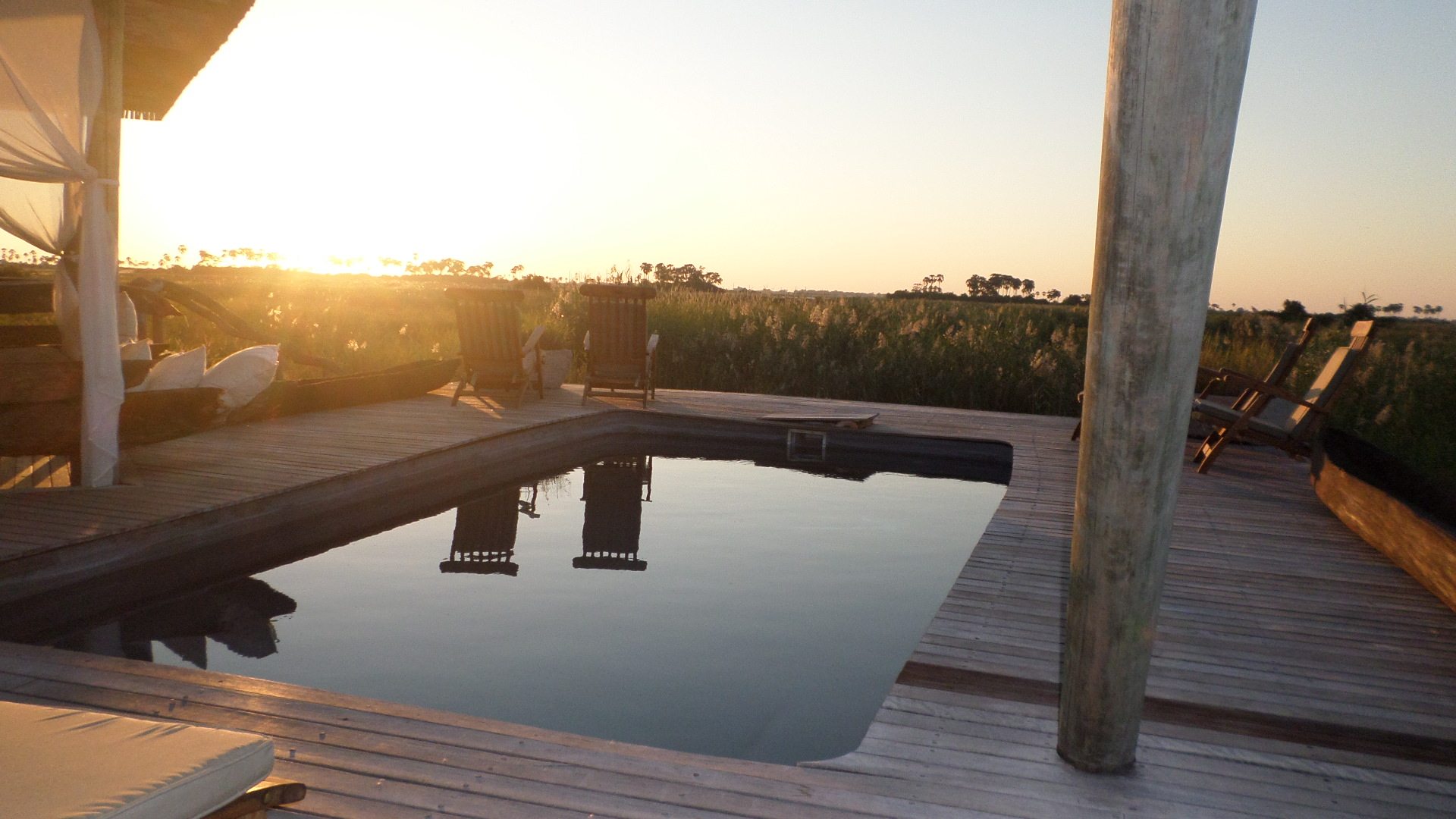 African lodge pool overlooking the landscape at sunset