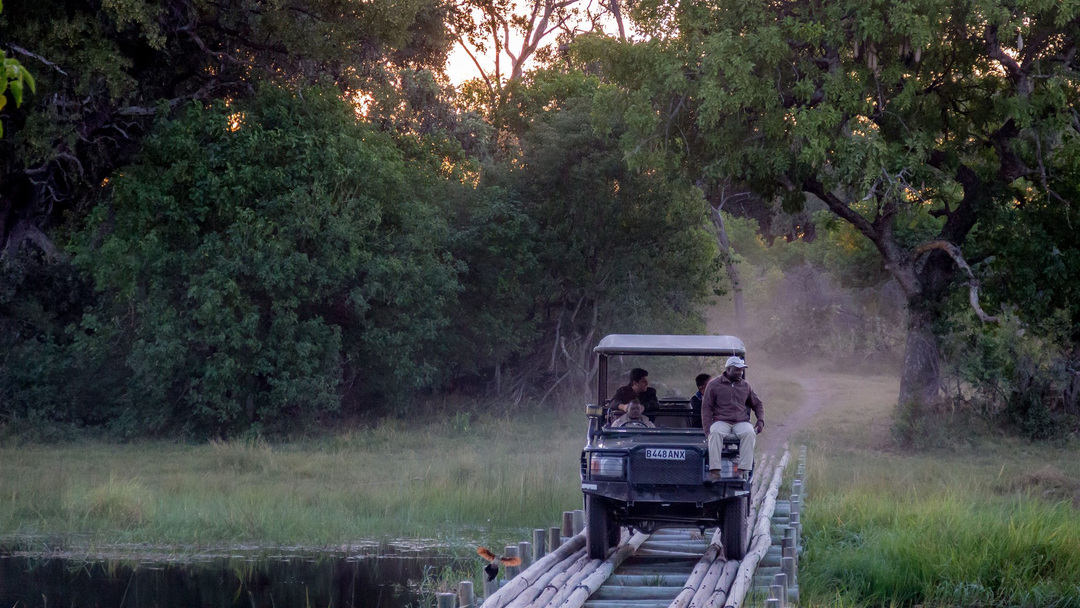 Safari vehicle crossing a timber bridge