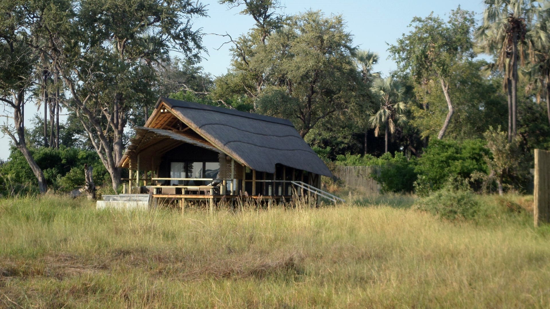 Secluded thatched safari lodge surrounded by African bush