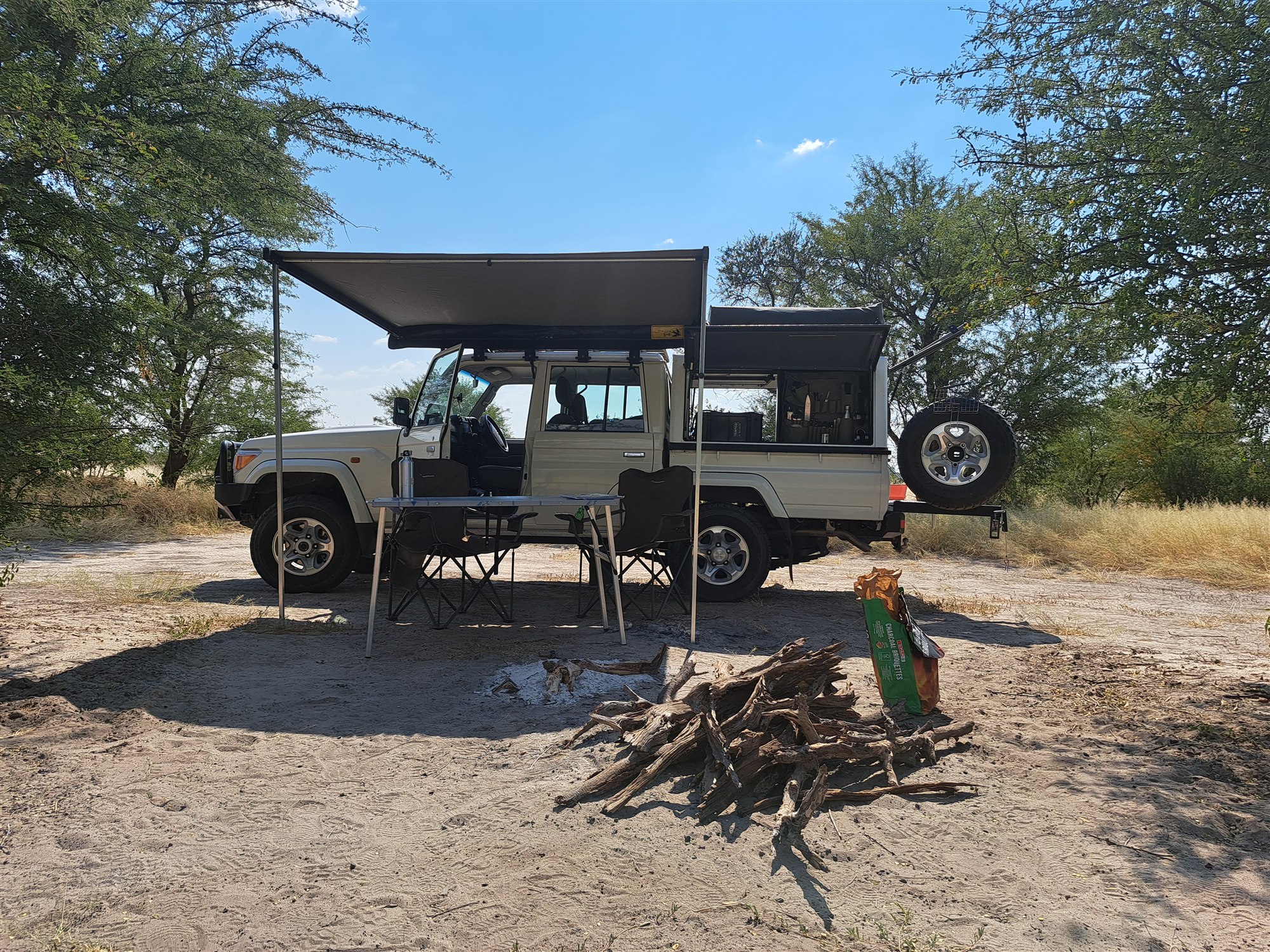 Fully equipped self-drive safari vehicle set up at a bush campsite